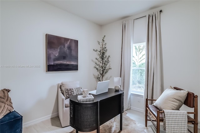 home office featuring baseboards and light tile patterned floors