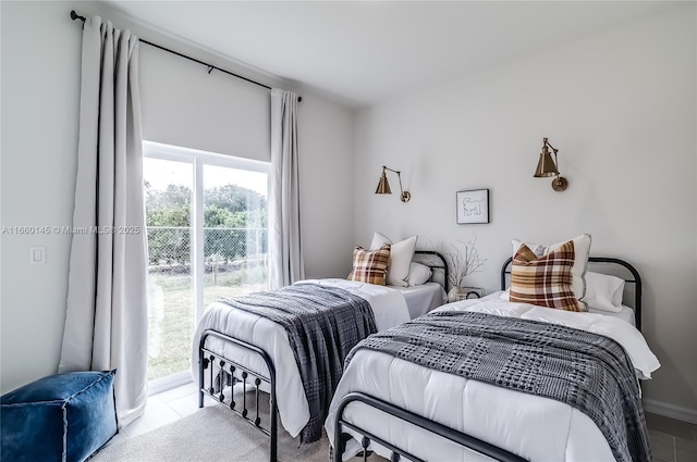 bedroom featuring access to exterior and light tile patterned floors