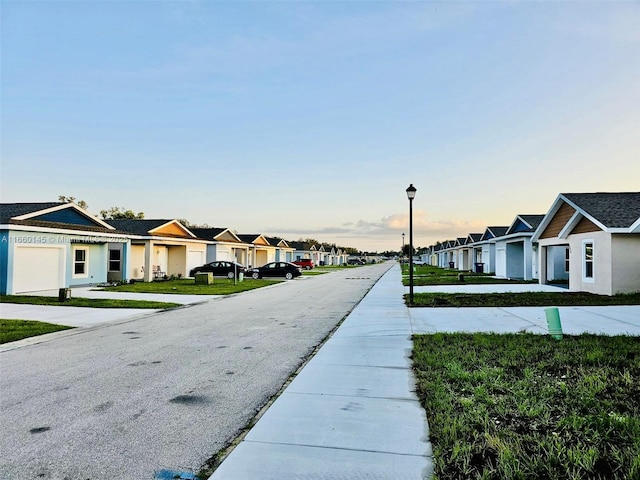 view of road featuring a residential view and street lights