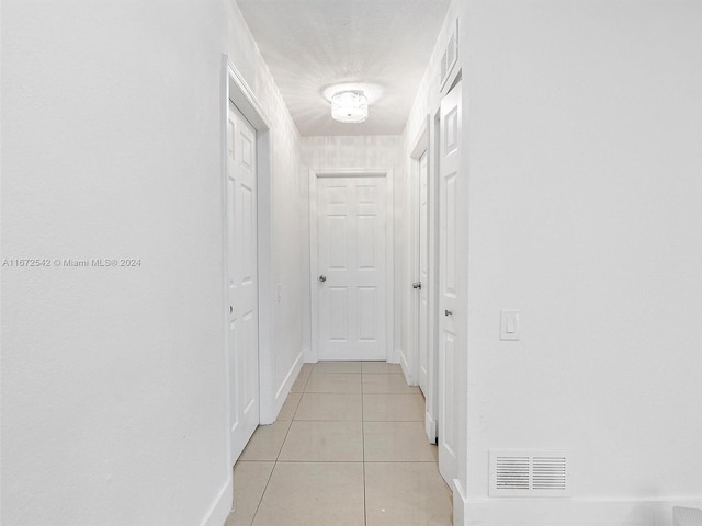 hallway with light tile patterned flooring