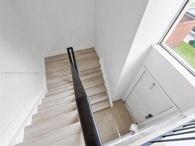 staircase with hardwood / wood-style flooring