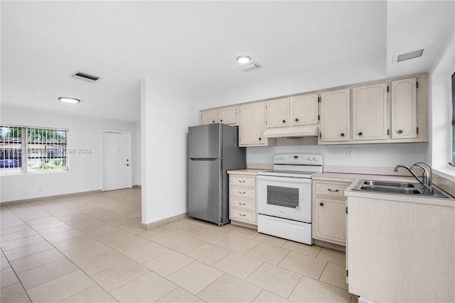 kitchen with electric range, stainless steel fridge, light tile patterned flooring, and sink