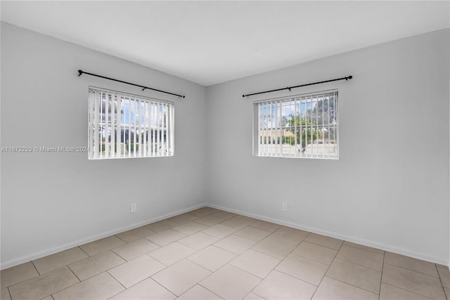 spare room featuring light tile patterned floors