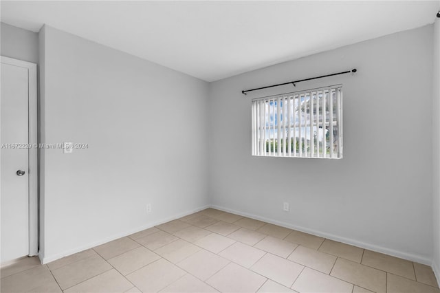 spare room featuring light tile patterned floors