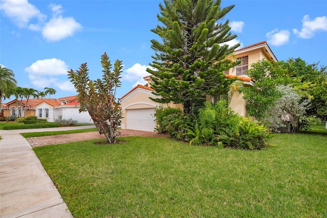 view of front of house with a garage and a front yard