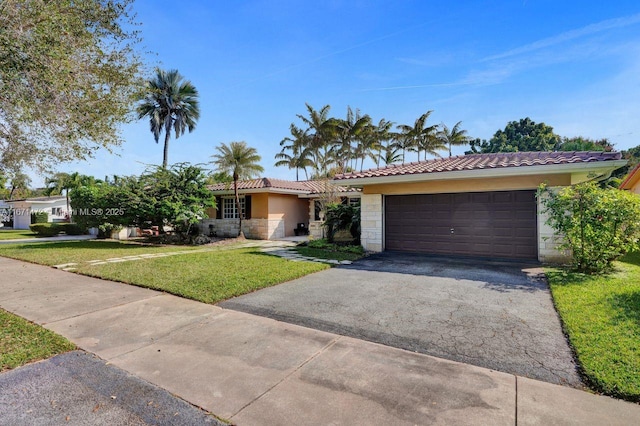 ranch-style house featuring a garage and a front yard