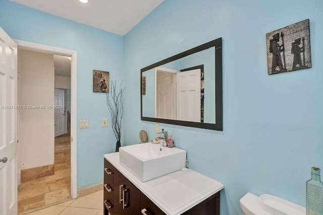 bathroom with vanity, tile patterned flooring, and toilet