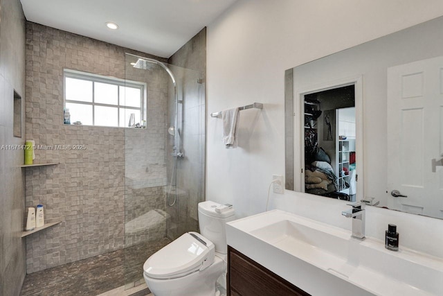 bathroom featuring vanity, toilet, and walk in shower