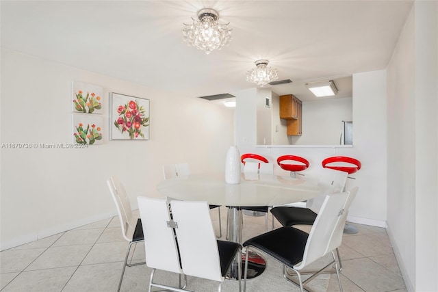 dining room featuring a notable chandelier and light tile patterned flooring