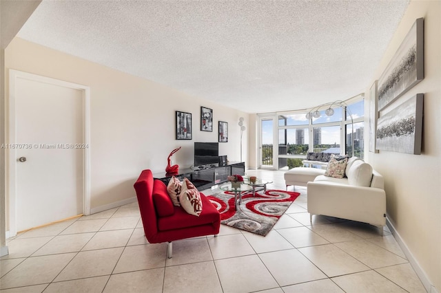 tiled living room with a textured ceiling and floor to ceiling windows