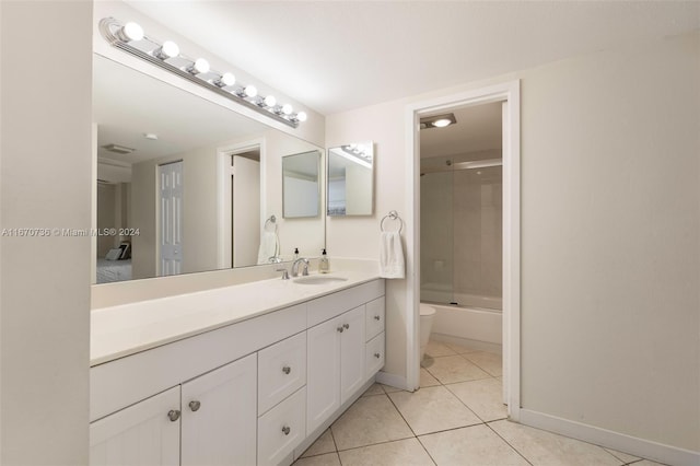 full bathroom with tile patterned flooring, shower / bath combination with glass door, vanity, and toilet