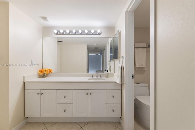 bathroom with a shower, vanity, toilet, and tile patterned floors