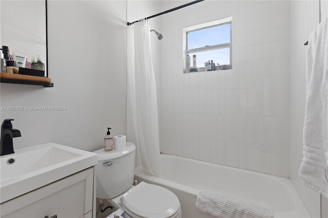 full bathroom featuring shower / tub combo with curtain, vanity, and toilet