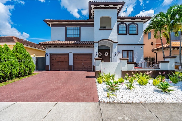 mediterranean / spanish home with a garage