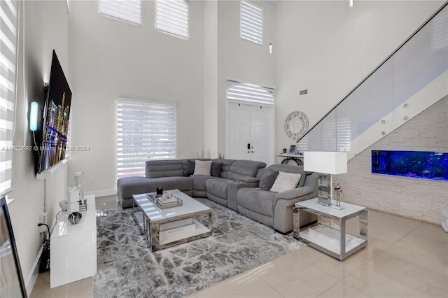 tiled living room featuring a high ceiling