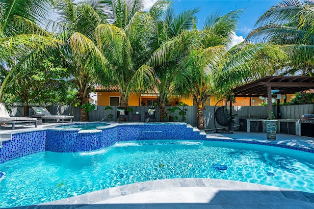 view of swimming pool featuring a patio and an in ground hot tub