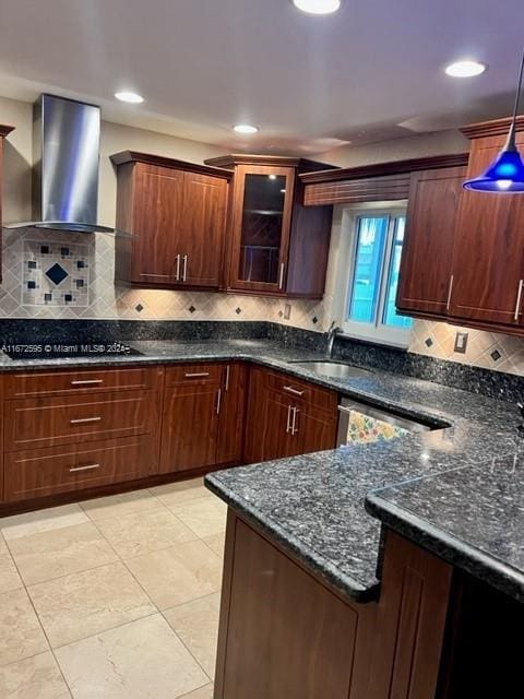 kitchen featuring black electric cooktop, hanging light fixtures, dark stone countertops, wall chimney exhaust hood, and dishwasher