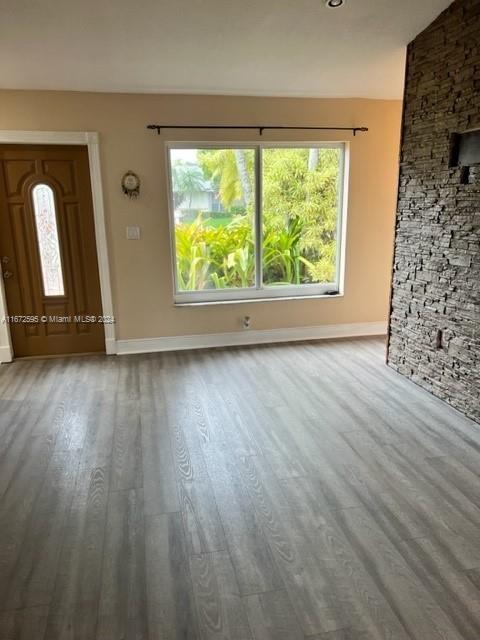 unfurnished living room with wood-type flooring