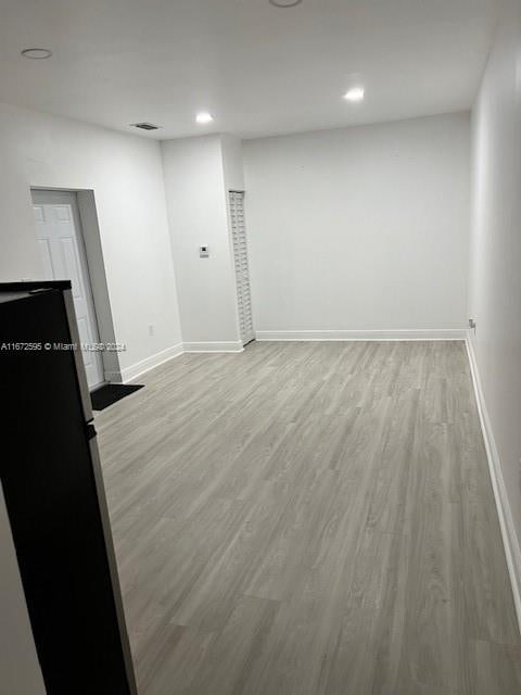 unfurnished living room with light hardwood / wood-style flooring