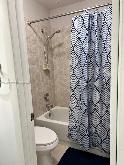 bathroom featuring shower / bath combo, toilet, and tile patterned floors