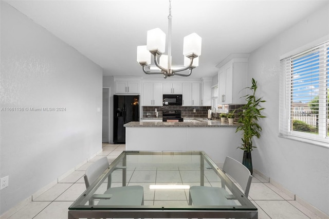 kitchen featuring hanging light fixtures, decorative backsplash, white cabinetry, kitchen peninsula, and black appliances