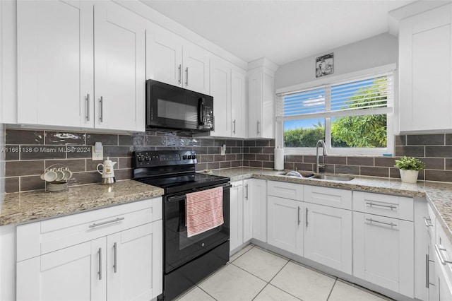 kitchen with backsplash, white cabinets, black appliances, and sink