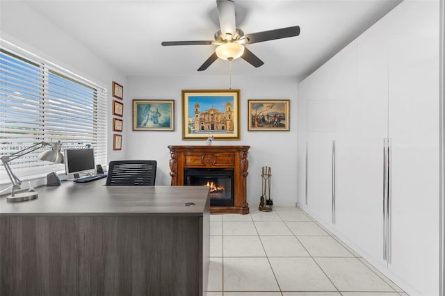 tiled office featuring ceiling fan