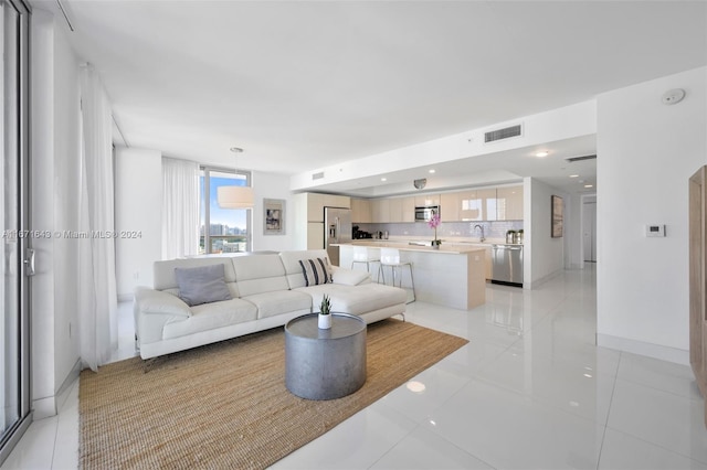 tiled living room featuring sink