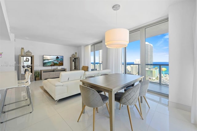 dining space with light tile patterned flooring and expansive windows