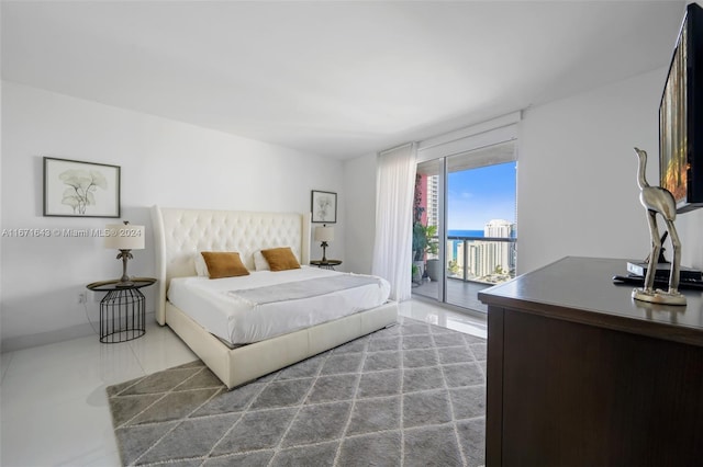 bedroom featuring tile patterned flooring and access to exterior