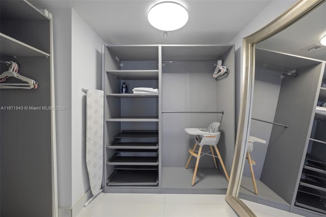 walk in closet featuring light tile patterned flooring