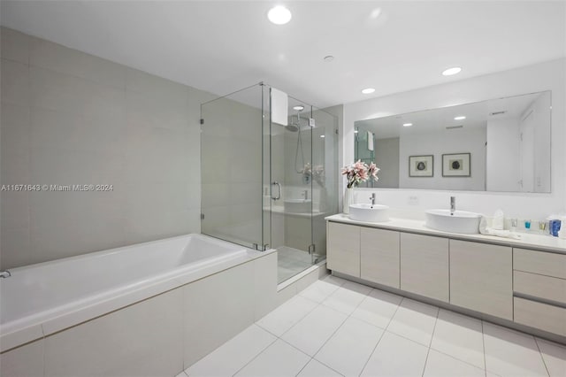 bathroom with shower with separate bathtub, tile patterned flooring, and vanity