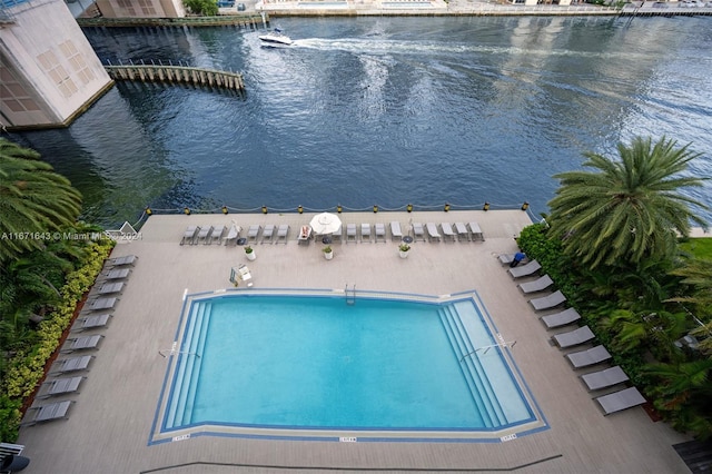 view of swimming pool with a water view