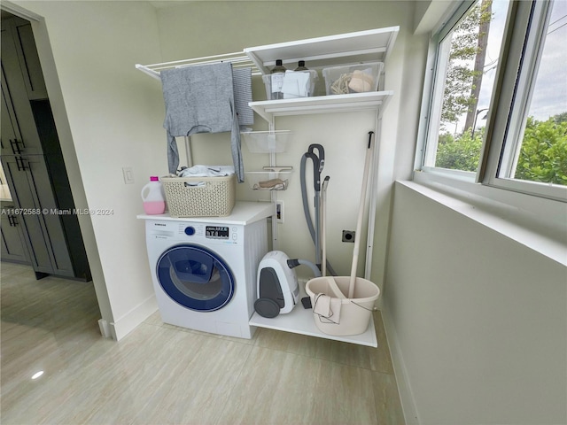 laundry room featuring washer / dryer and light wood-type flooring