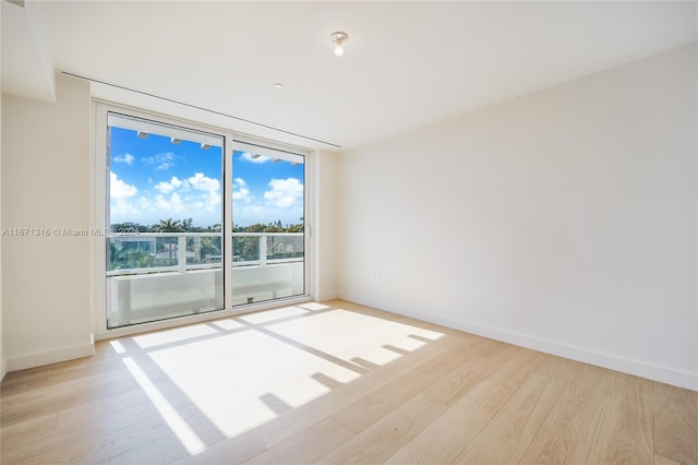 spare room with light hardwood / wood-style flooring