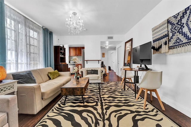 living room featuring dark hardwood / wood-style flooring and a notable chandelier