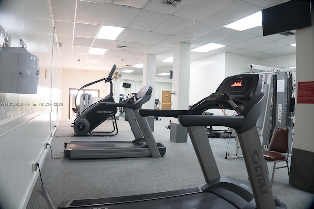 exercise room featuring a drop ceiling