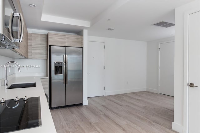 kitchen featuring light hardwood / wood-style flooring, appliances with stainless steel finishes, and sink