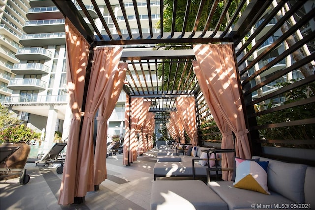 view of patio / terrace featuring a pergola, a balcony, and an outdoor hangout area