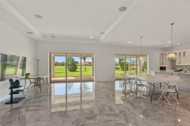 living room featuring a tray ceiling and ornamental molding