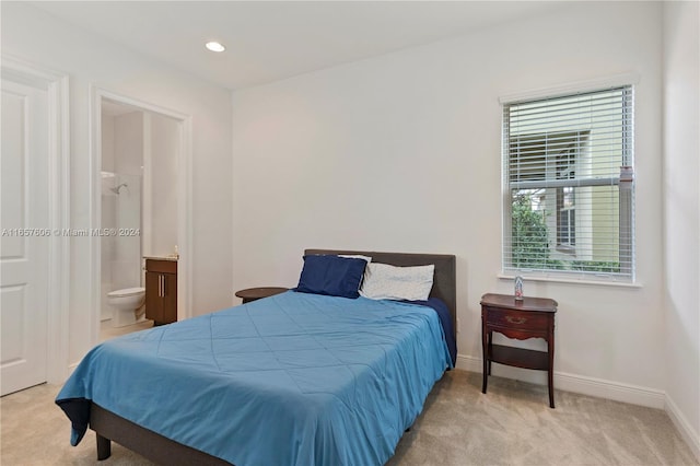 carpeted bedroom with ensuite bath