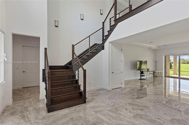 staircase with a high ceiling