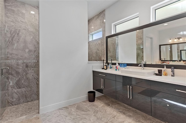 bathroom with vanity and a shower with door