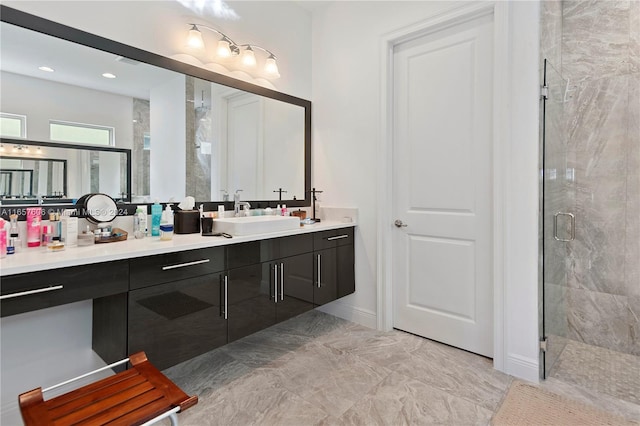 bathroom featuring vanity and a shower with door