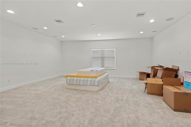 sitting room featuring light colored carpet