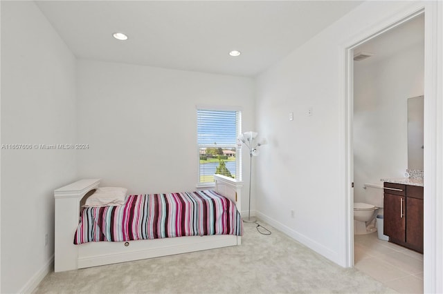 carpeted bedroom with connected bathroom