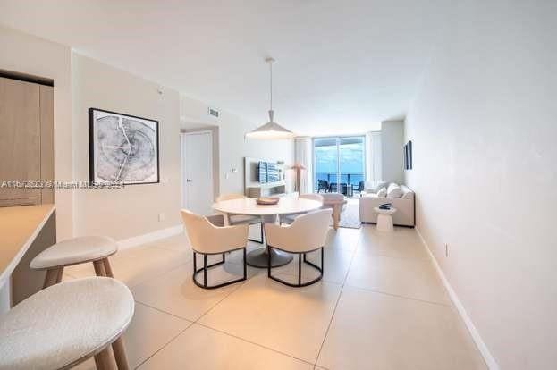 dining area with light tile patterned floors