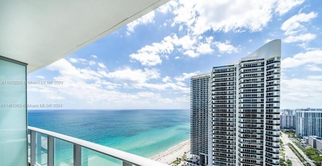 balcony with a view of the beach and a water view