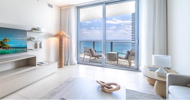 living room with a water view and light tile patterned flooring