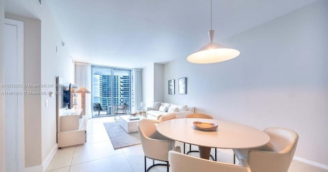 tiled dining space featuring expansive windows